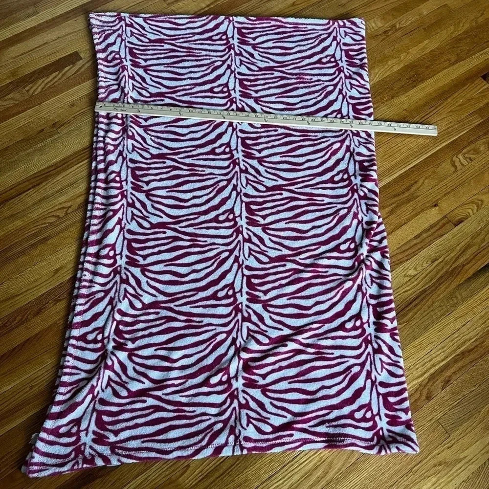 Plush pink and white zebra fleece throw